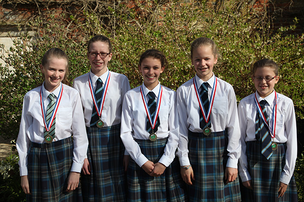 The senior girls cross country running team with their medals from the National Prep Schools Championships