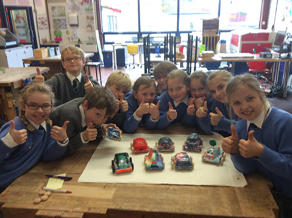 Year 4 pupils with their wind-up vehicles