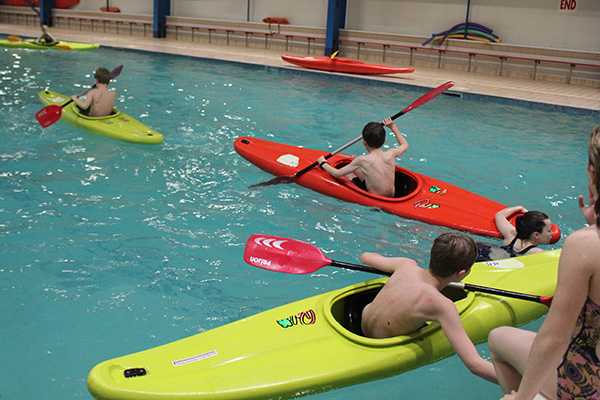 Boarders having fun kayaking in the swimming pool